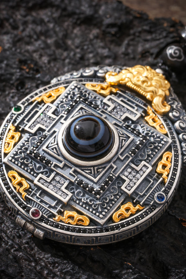 A mandala engraved in silver around a dzi bead
