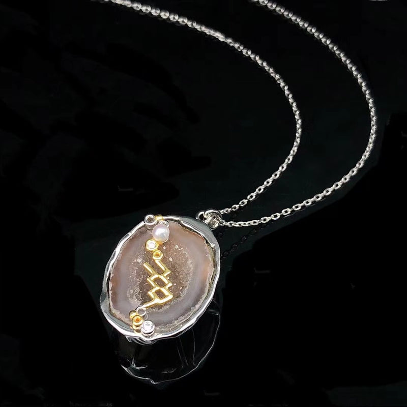 Aquarius crystal geode zodiac pendant with Aquarius symbol, angled view