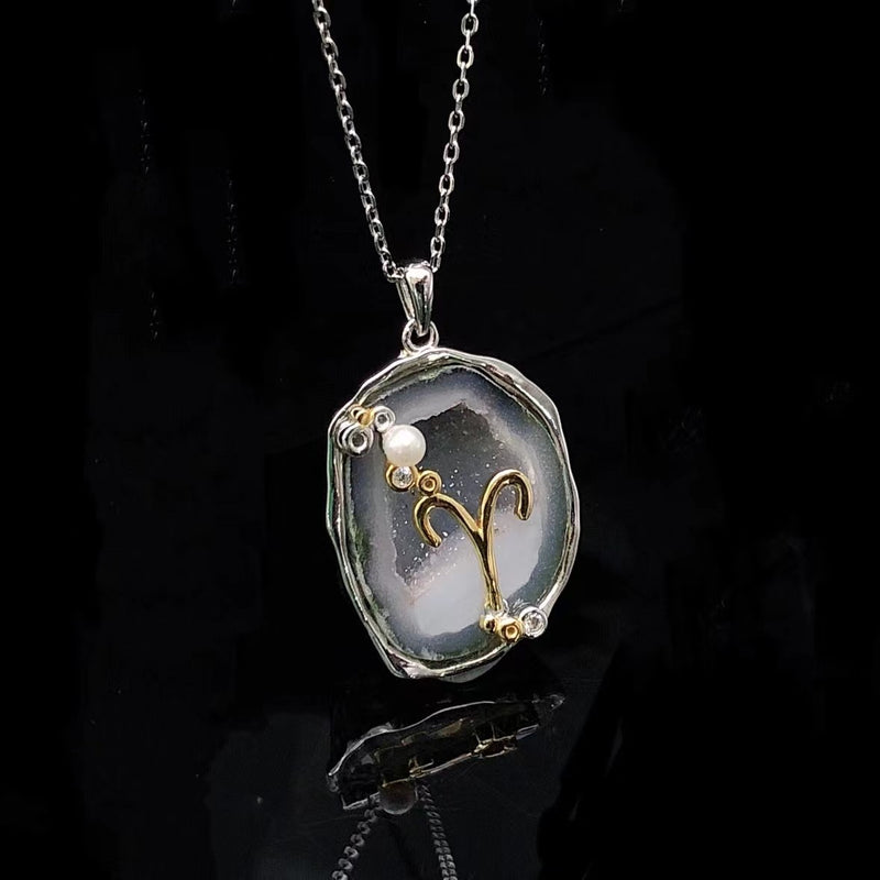Aries crystal geode zodiac pendant with Aries symbol, angled view