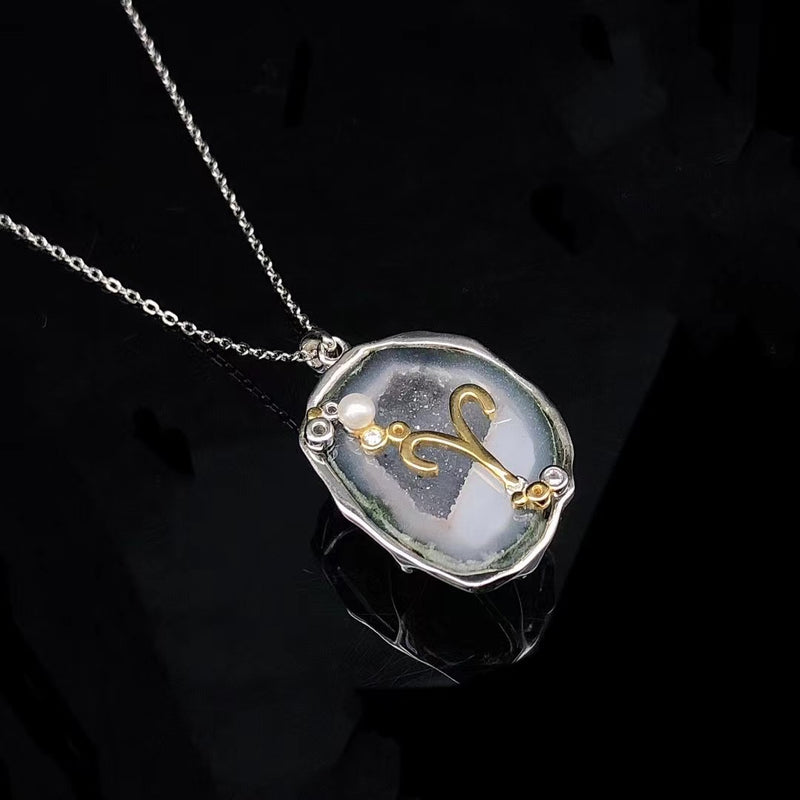 Aries crystal geode zodiac pendant with Aries symbol, angled view