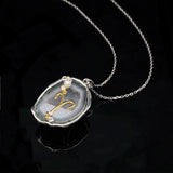 Aries crystal geode zodiac pendant with Aries symbol, angled view