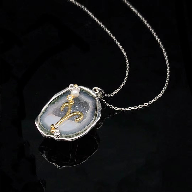 Aries crystal geode zodiac pendant with Aries symbol, angled view