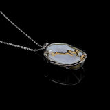 Capricorn crystal geode zodiac pendant with Capricorn symbol, angled view