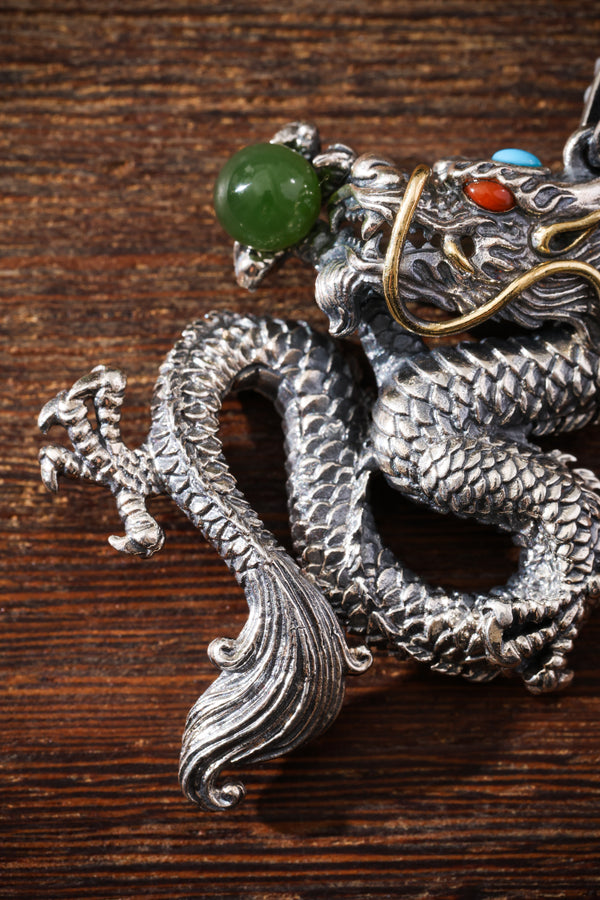 A silver dragon guardian holding a jade pearl