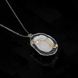 Gemini crystal geode zodiac pendant with Gemini symbol, angled view