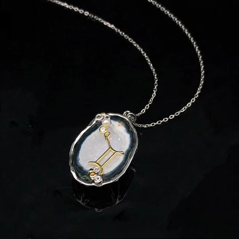Gemini crystal geode zodiac pendant with Gemini symbol, angled view