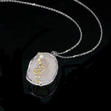 Leo crystal geode zodiac pendant with Leo symbol, angled view