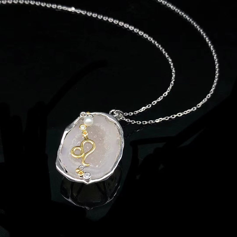 Leo crystal geode zodiac pendant with Leo symbol, angled view