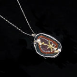Pisces crystal geode zodiac pendant with Pisces symbol, angled view