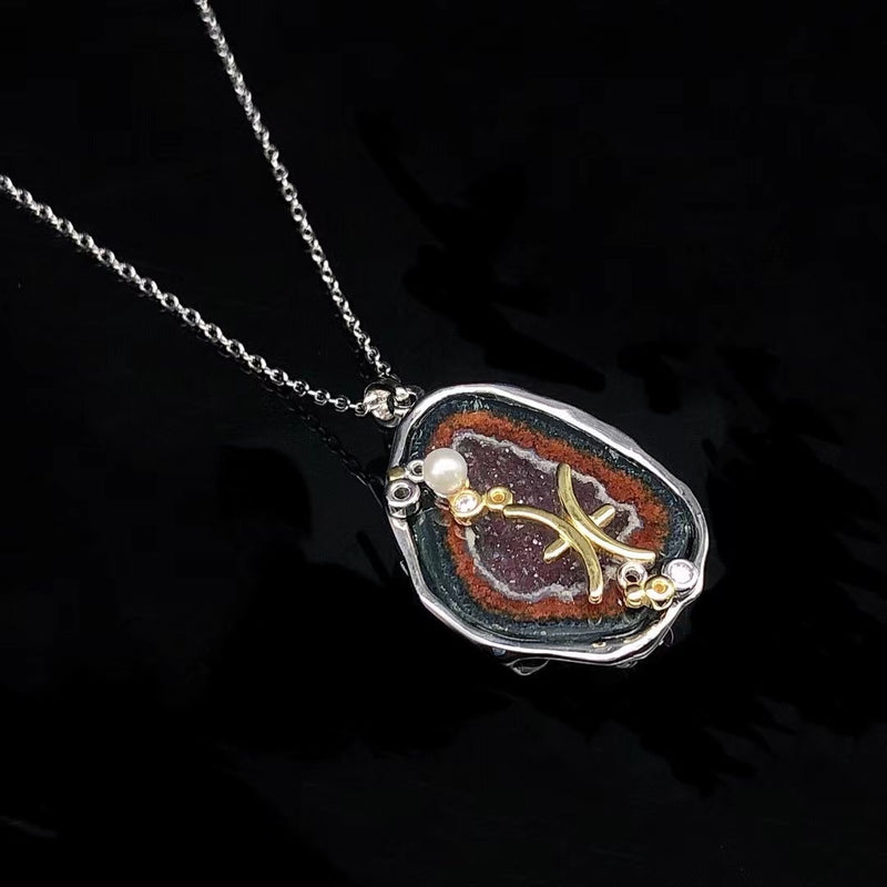 Pisces crystal geode zodiac pendant with Pisces symbol, angled view