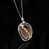 Sagittarius crystal geode zodiac pendant with Sagittarius symbol, angled view