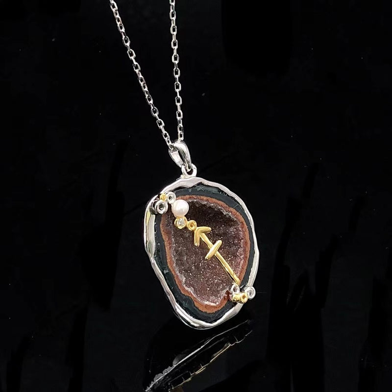 Sagittarius crystal geode zodiac pendant with Sagittarius symbol, angled view