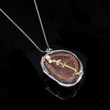 Sagittarius crystal geode zodiac pendant with Sagittarius symbol, angled view