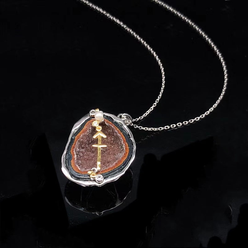 Sagittarius crystal geode zodiac pendant with Sagittarius symbol, angled view