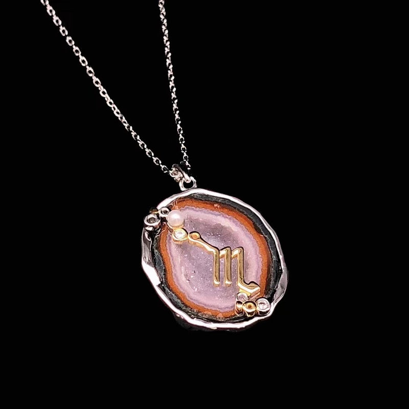 Scorpio crystal geode zodiac pendant with Scorpio symbol, angled view