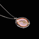 Scorpio crystal geode zodiac pendant with Scorpio symbol, angled view