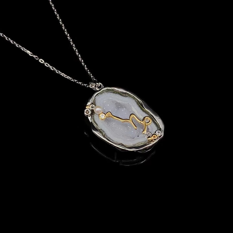 Capricorn crystal geode zodiac pendant with Capricorn symbol, angled view